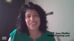 Smiling woman with curly dark hair in a green top, speaking on a video call; caption reads 'WeAreFieldtrip.com'.