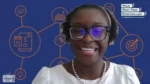 Smiling woman with glasses and pearl necklace on a video call, blue background with finance icons and Your Part-Time Controller logo.
