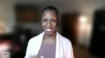 Smiling Black woman wearing a headset on a video call, blurred home office background, 'The Nonprofit Show' logo in the bottom-left corner.