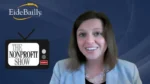 Smiling woman in a light blue blazer hosts The Nonprofit Show, with Eide Bailly and The Nonprofit Show logos in the blue studio background.