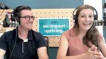 Two podcast hosts wearing headphones sit at microphones in a studio; a blue poster behind them reads 'an impact uprising'.