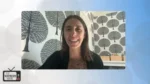Woman smiling on a video call, wearing a leopard print top with a black cardigan, against a black‑and‑white tree wallpaper; The Nonprofit Show logo appears bottom left.