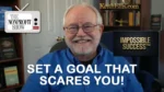 Smiling man host on a video thumbnail with The Nonprofit Show logo on the left and Impossible Success graphic on the right, with the caption 'Set a goal that scares you!' across the bottom.