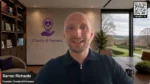 Man speaking in a modern office with the Charity AI Partners logo on the wall behind him.