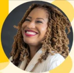 Portrait of a smiling woman with curly brown hair, wearing a cream sweater, against a dark background with geometric yellow shapes in the frame.
